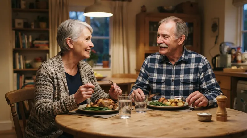 A married couple in their late sixties talking over supper at a round kitchen table